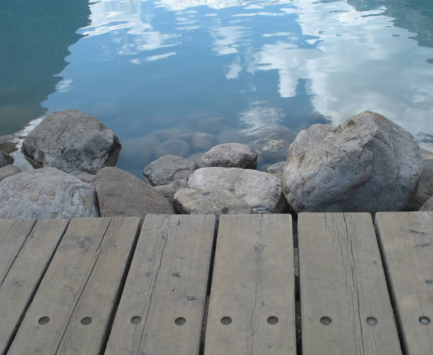 wooden pier and stones near the wate
