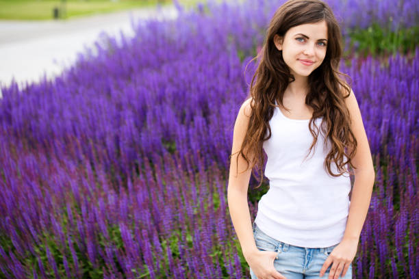 Young beautiful girl on lavender background. Lifestyle.