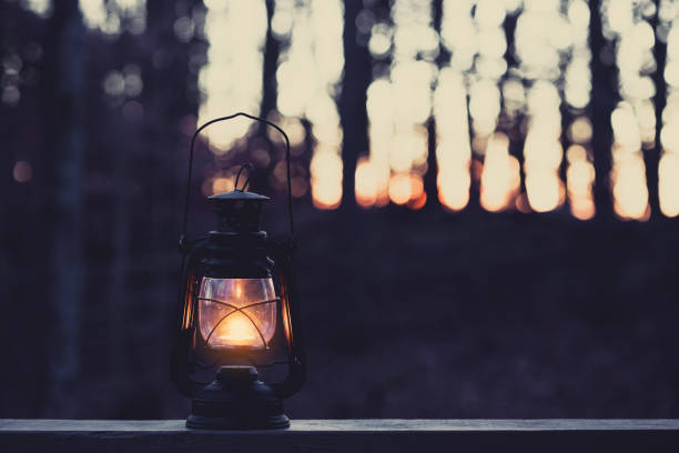 istock Vintage style lamp with a candle at night 858110812