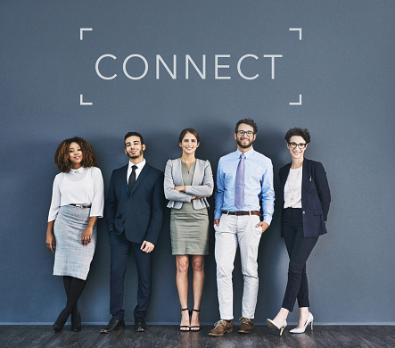 Studio shot of a group of businesspeople standing in line with the word connect above them against a gray background