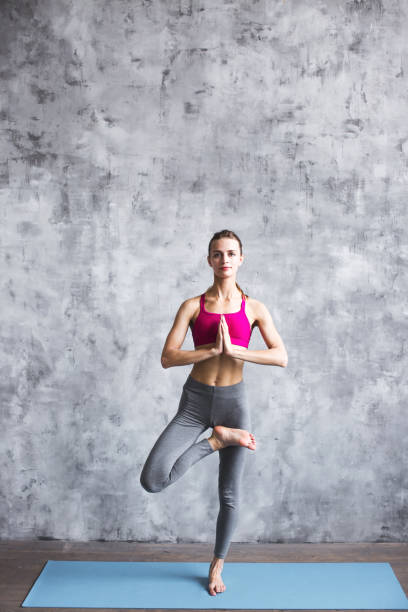 istock Beautiful woman doing yoga tree position. 858112068