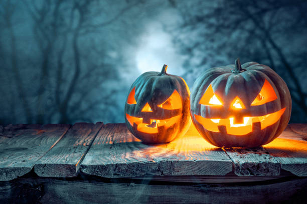 istock Halloween pumpkins on blue background 858118498