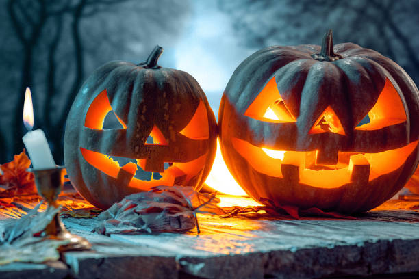 istock Halloween pumpkins on blue background 858119360