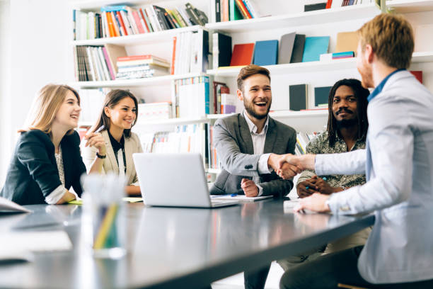 istock Businesspeople shaking hands in office 858119754