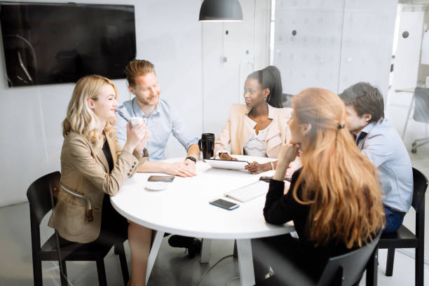 istock Group of business people sitting at desk 858123256