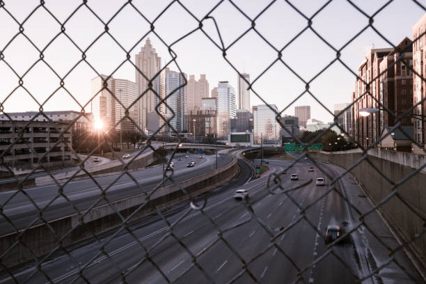 istock Morning city skyline through the wire mesh fence 858126356