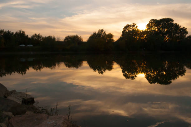 istock lake at sunset, reflections on water 858127382