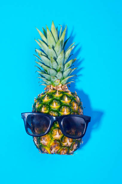istock Pineapple and sunglasses on blue background 858131608