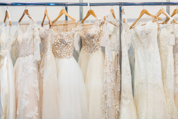 Many beautiful wedding dresses Many beautiful wedding dresses hang in the store wedding dress photos stock pictures, royalty-free photos & images
