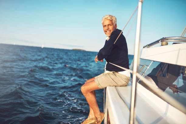 istock Smiling mature man enjoying a day sailing on the ocean 858136878