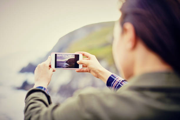 istock Woman photographing nature using smart phone 858144264