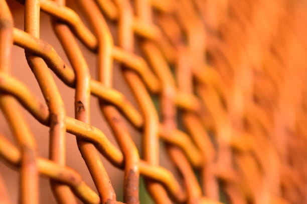 istock Weathered yellow paint with rust poking through on protective metal cage 858144540