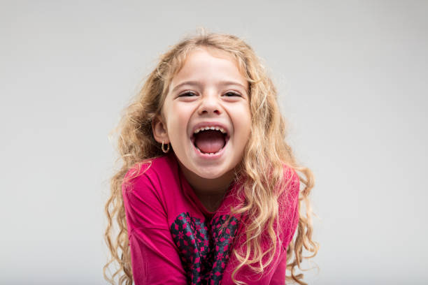 laughing schoolgirl with curly hair - mirth imagens e fotografias de stock