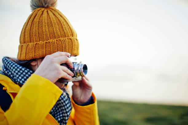 istock Hiker photographing with vintage camera against clear sky 858148502