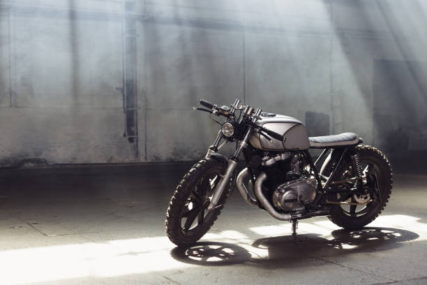 istock motorcycle standing in dark building in rays of sunlight 858148616