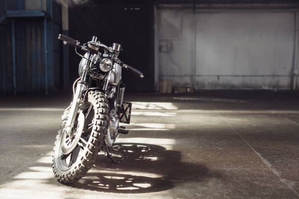 istock motorcycle standing in dark building in rays of sunlight 858148898