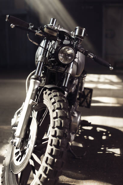 istock motorcycle standing in dark building in rays of sunlight 858151194
