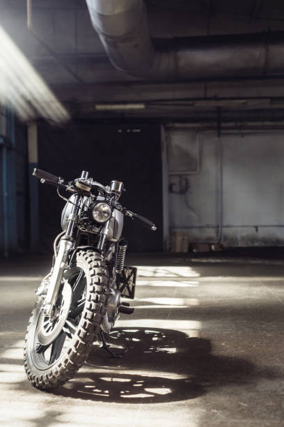 istock motorcycle standing in dark building in rays of sunlight 858151258