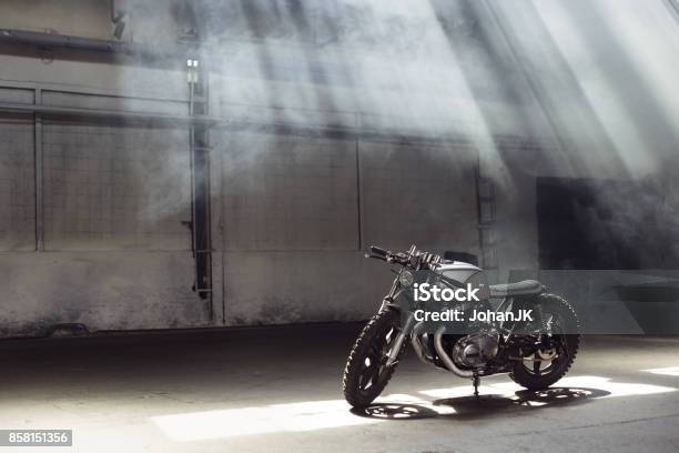 Motorcycle Standing In Dark Building In Rays Of Sunlight Stock Photo - Download Image Now