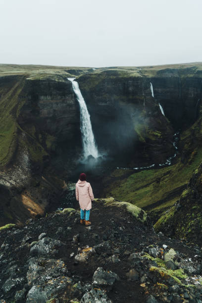 istock Woman walking near   Haifoss waterfall in mountains 858153618
