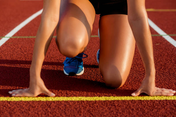 istock Close-up of woman's legs on start before jogging 858156932