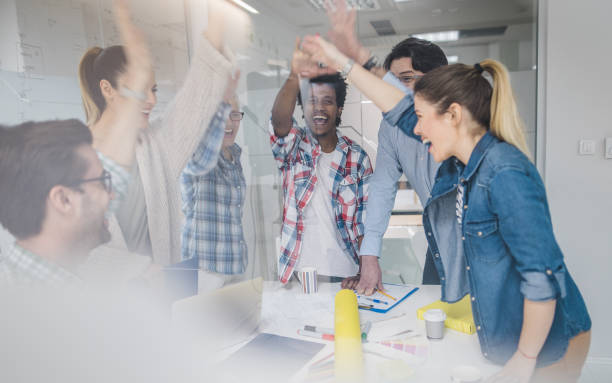 istock Cheerful start up team celebrating successful business project in the office. 858157736