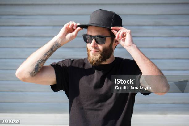 Hipster Handsome Male Model With Beard Wearing Black Blank Baseball Cap With Space For Your Logo Stock Photo - Download Image Now