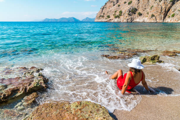 istock Woman enjoying summer vacations on beach 858164044