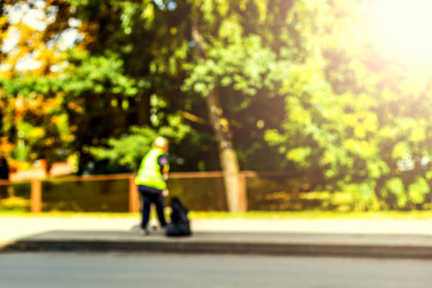 istock Abstract blurred background  - road sweeper worker cleaning city street with broom tool 858164502