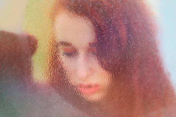 istock Autumn outdoor girl redhead behind patterned glass 858164536