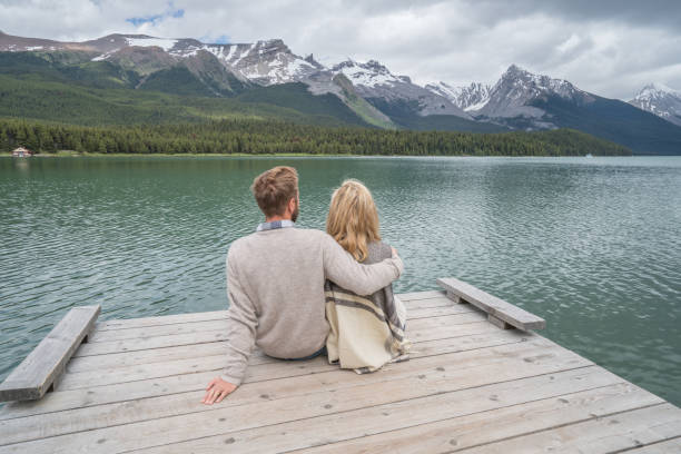 istock Young couple relaxing on lake pier 858169164