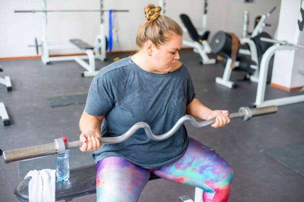istock Fat girl in a gym 858171884