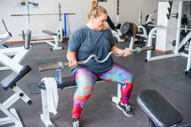 istock Fat girl in a gym 858171986