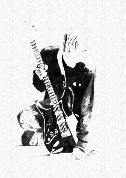 Photo of a young man with long hair playing electric guitar on stage.
