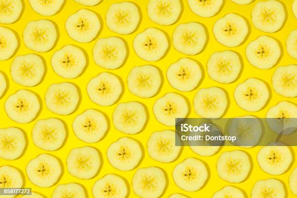 Slices Of Fresh Bananas On Yellow Background Stock Photo - Download Image Now - Banana, Pattern, Slice of Food