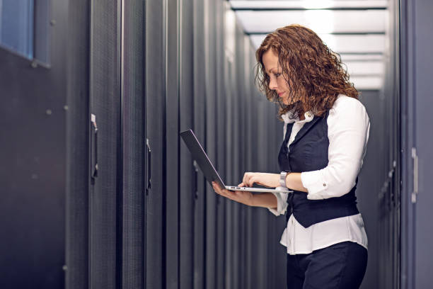 istock Adult Female Technician working in Server Room Setting 858177562