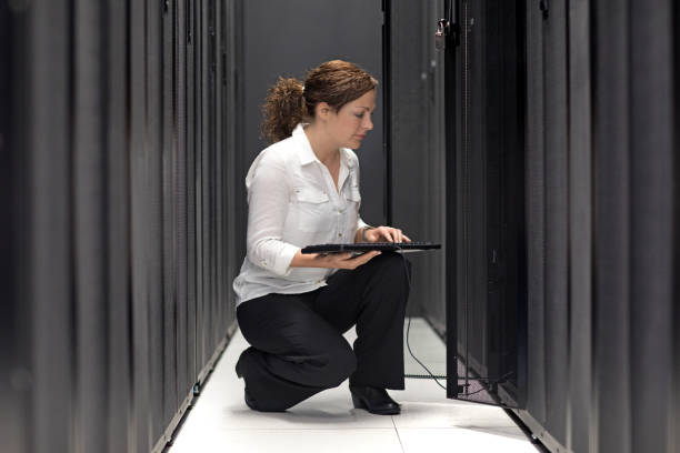 istock Adult Female Technician working in Server Room Setting 858178118