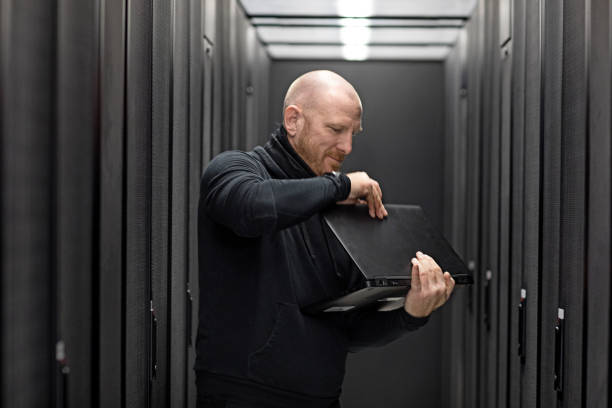istock Adult Male Technician working in Server Room Setting 858178184