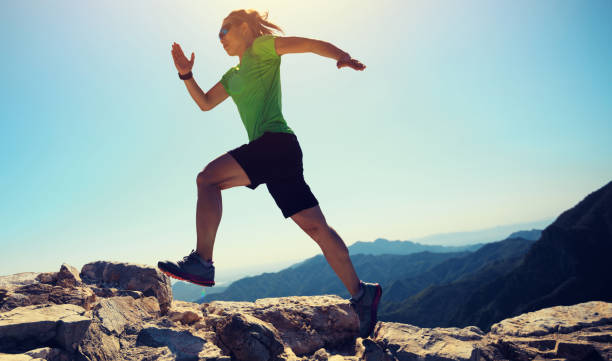 istock woman trail runner running at mountain top 858178298