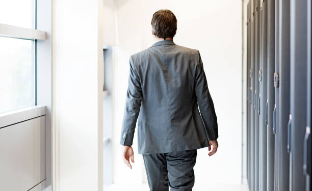 istock Adult Male Technician Manager working in Server Room Setting 858178438