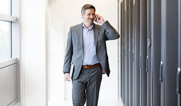 istock Adult Male Technician Manager working in Server Room Setting 858178444
