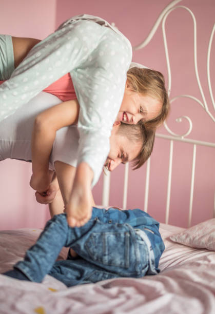 istock Father playing in bed with his children 858179090