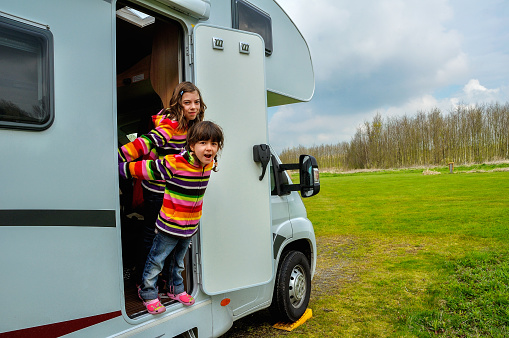 Kids in camper (rv), family travel in motorhome on vacation
