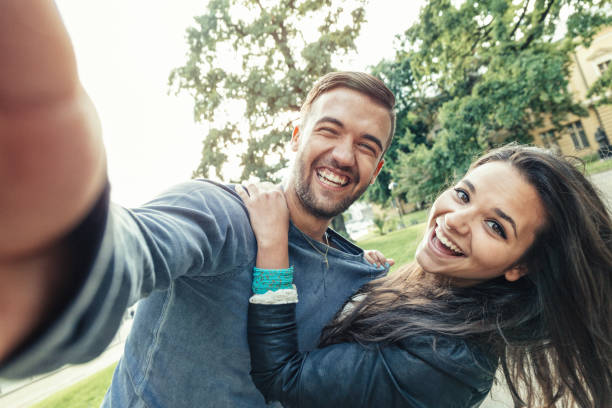 istock Beautiful young couple taking photos and having fun 858181980