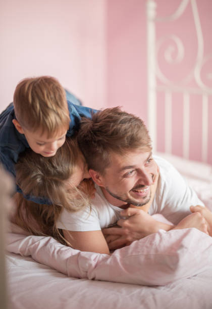 istock Father playing in bed with his children 858182238