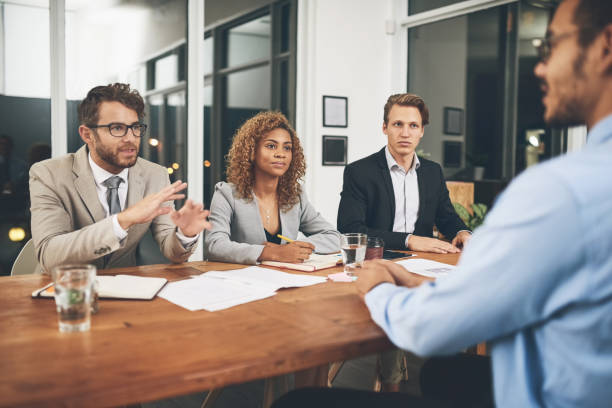 Tell us why we should hire you? Shot of a group of businesspeople interviewing a candidate in an office together for yes stock pictures, royalty-free photos & images