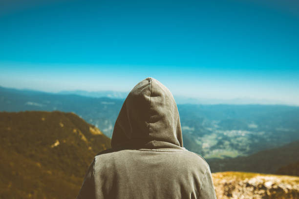 istock Unrecognizable female person standing at high mountain viewpoint 858195768
