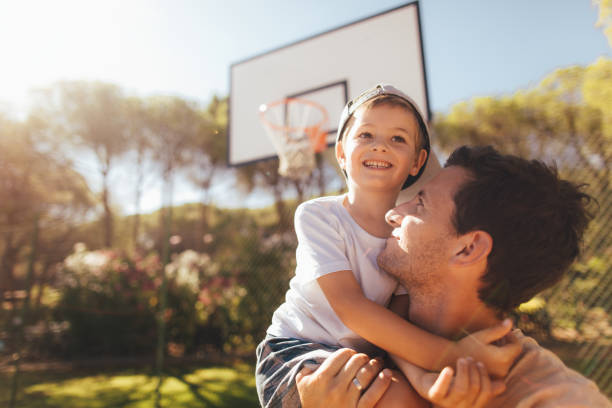 On basketball court with my dad Smiling father and son on basketball court basketball sport photos stock pictures, royalty-free photos & images