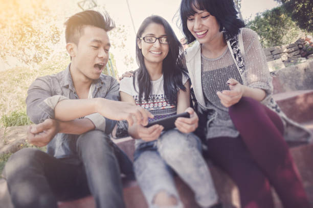 istock Multiethnic happy, college friends together sharing smart phone. 858197638