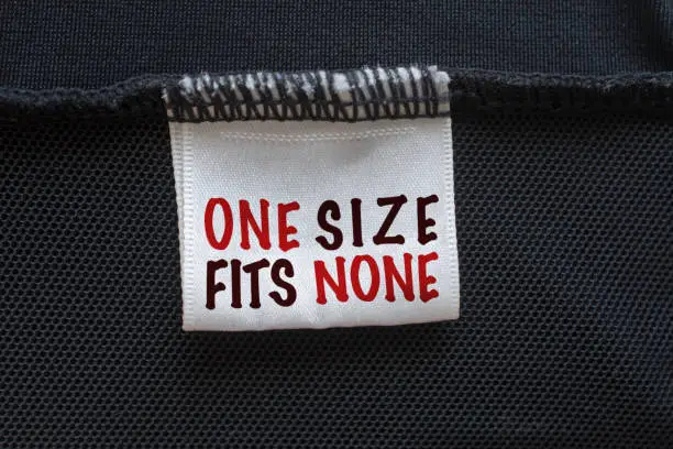 Extreme close up woman bathing suit with the label One size fits none